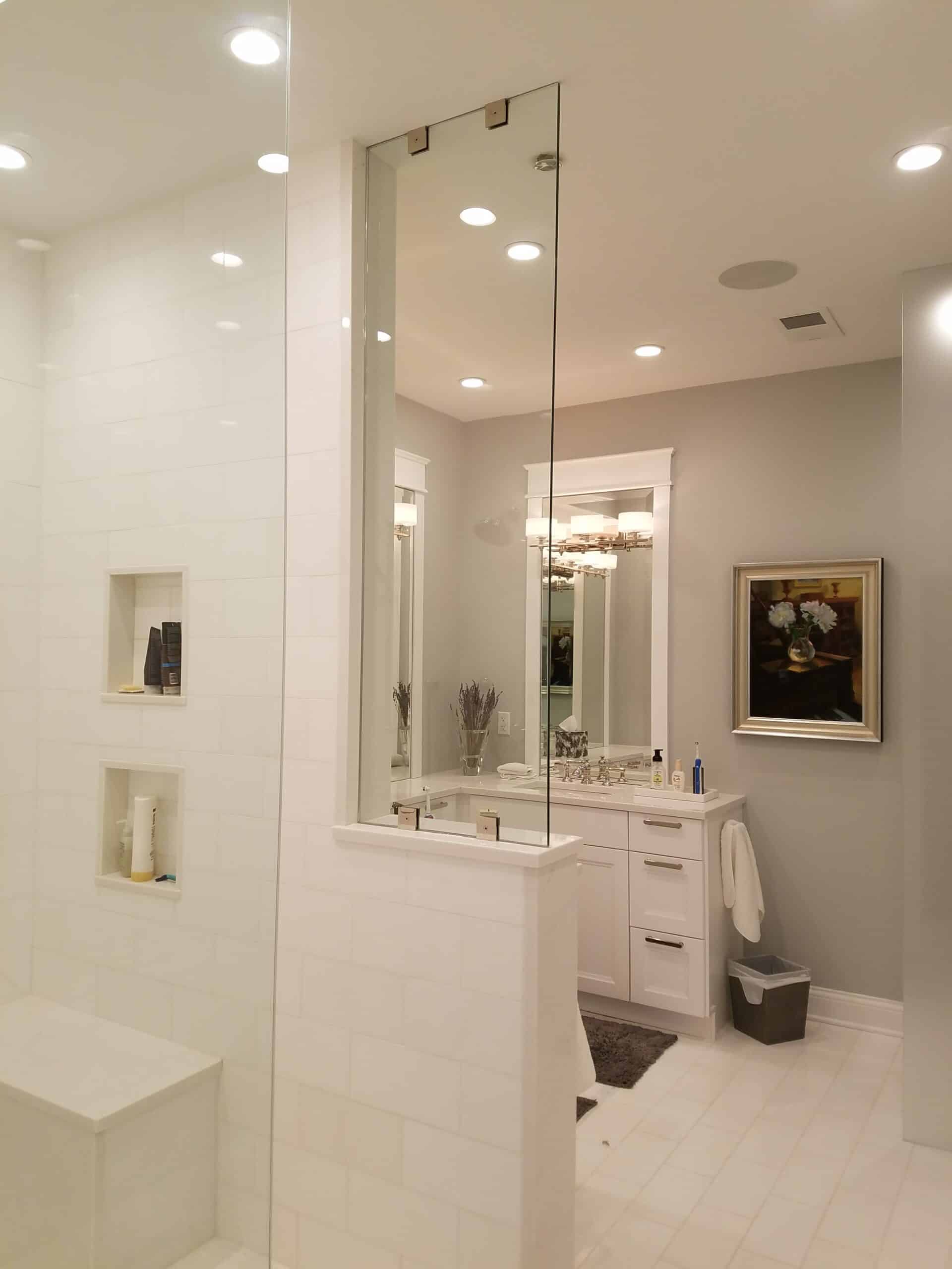A spacious bathroom remodel featuring a walk in shower and separate vanity area