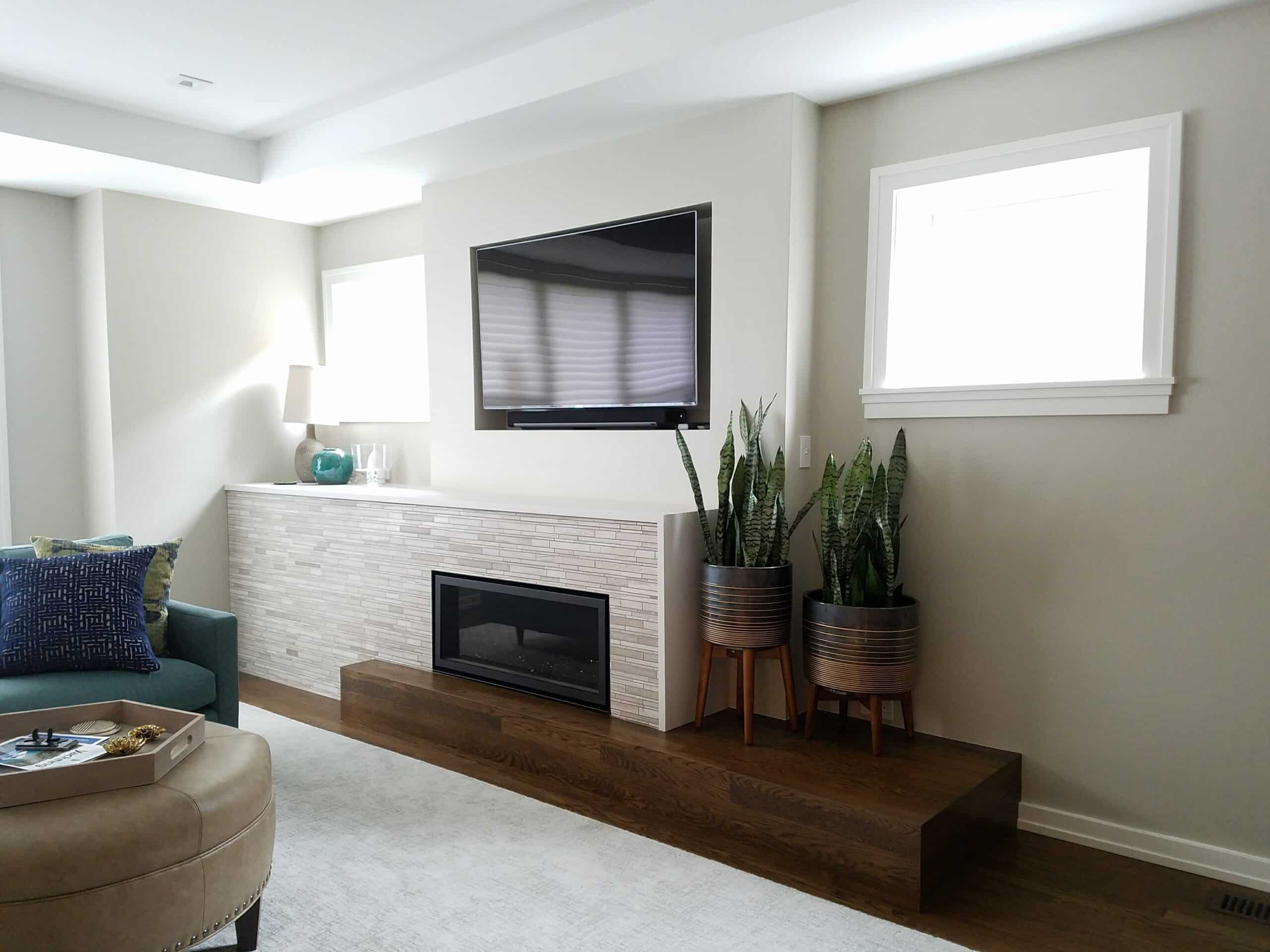 A beautiful update to a living room in Chicago with white stonework around the fireplace
